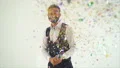 The man opening poppers with confetti. slow motion 4k or 4k+ Resolution