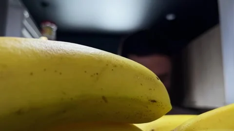 Man opening the refrigerator and taking an banan and avocado from the shelf Stock Footage 257314880