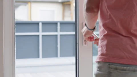 Man opening terrace door by pulling metal handle with both hands Stock Footage 341278895
