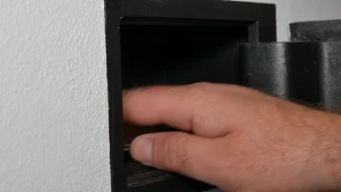 Man opening vault or safety deposit box in hotel, hand typing security code and 库存影片 90331830