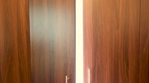 Man opening a wardrobe closet full of disposable masks hanging instead of clo Stock Footage 134133018