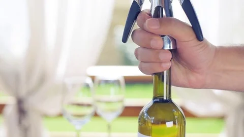 Man opening a wine bottle with a corkscrew . Video stock 77438346