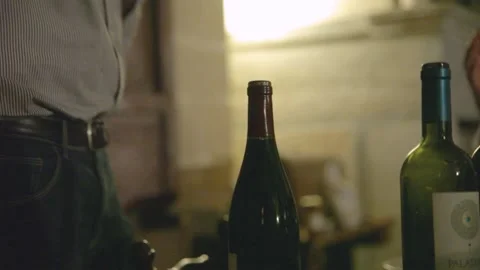 Man opening wine bottle with a corkscrew close-up. Opening a bottle of wine. Stock Footage 166318070