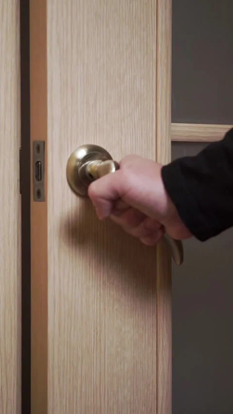 A man opens and closes a door to a room Stock Footage 310538953