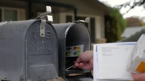 Man Opens and closes mail box Stock Footage 95820998