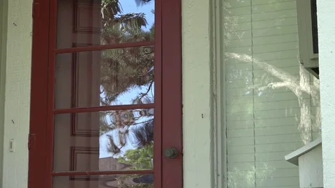 A Man Opens  and Locks Front Door, Puts Mail in Mailbox and Leaves Home Stock Footage 79111056