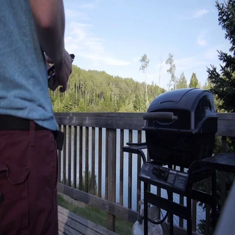 Man opens Barbecue (BBQ) Stock Footage 69333642
