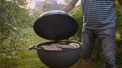 Man opens barbecue at the cottage Stock Footage 44448962