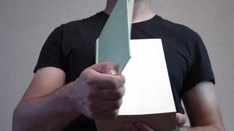 Man opens a big book 4K Video stock 205569271