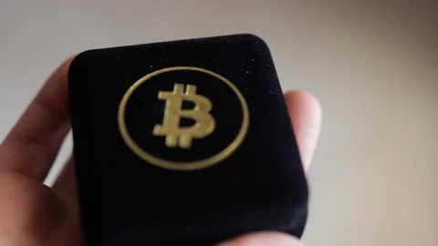 Man Opens Bitcoin Case In His Hand. Close Up shot Stock Footage 129635968
