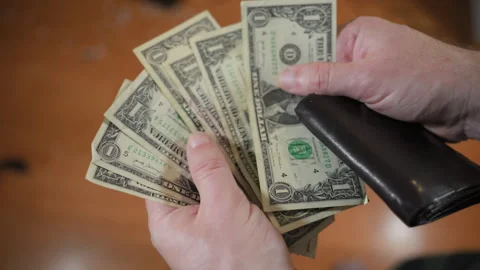 Man opens black wallet with a few 1 dollar notes. Close shot Stock-Footage 294148905