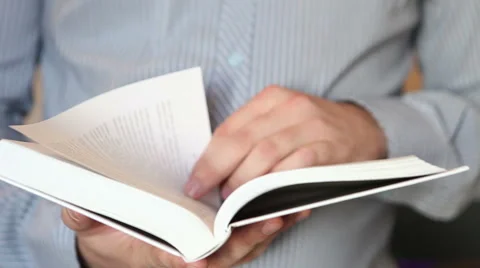 Man opens the book and starts flipping it. part closeup Stock Footage 64830560
