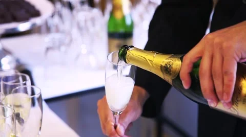 A man opens a bottle of champagne and pours into the glass Stock Footage 52815384
