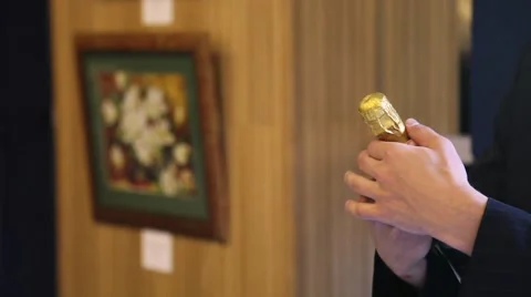 A man opens a bottle of champagne and pours into the glass Stock Footage 52815412