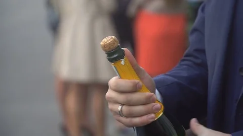 Man Opens A Bottle Of Champagne Stock Footage 76597392