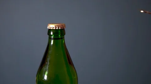 Man opens bottle with fizzy drink with a special opener. Glass bottle with metal Видео 113215072