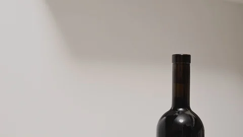 A man opens a bottle of wine with a metal corkscrew Stock Footage 128192287