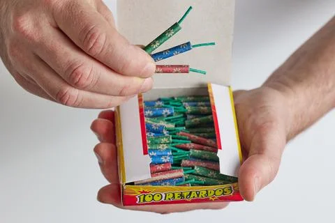 A man opens a box of firecrackers Stock Photos