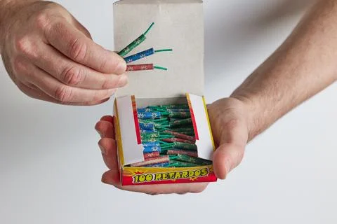 A man opens a box of firecrackers Stock Photos