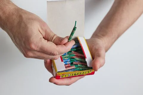 A man opens a box of firecrackers Stock Photos