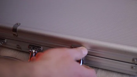 A man opens a box with poker chips in casino. He pulls out the chips and throws Stock Footage 124132778