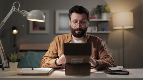 Man opens box positive emotions. Happy bearded male buyer opens received package Stock Footage 188733825