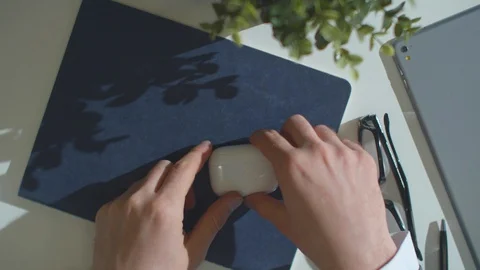 Man opens a box of wireless headphones and puts them on Stock Footage 129986599