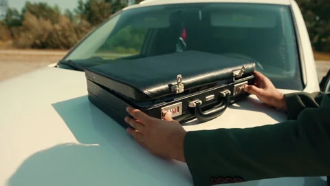 Man opens briefcase and then changes his mind and closes it back Stock Footage 160808634