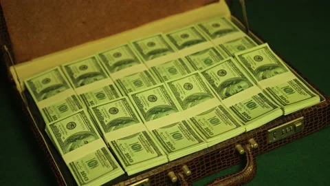 Man opens briefcase full of 100 dollars currency notes in a dimly lit nightcl Stock Footage 230235460