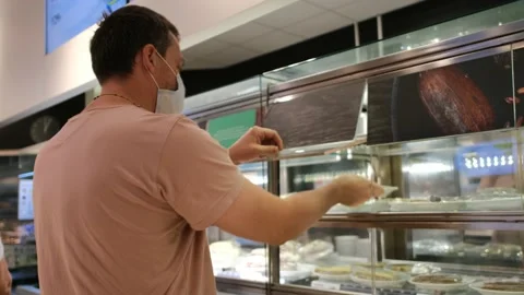 Man opens cafe window and takes white plate in store Video stock 156682607