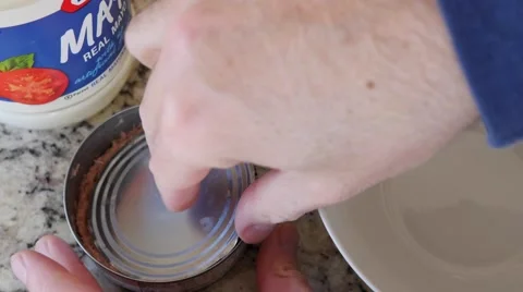 A man opens a can of tuna fish for sandwich Stock Footage 57877637
