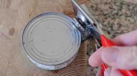 A man opens a can of tuna fish Stock Footage 57877829