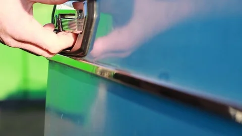 A man opens the car door and checks the door handle and closes it back Stock Footage 85280344