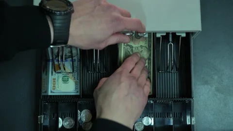 Man opens cash register, puts bill in, takes change, closes drawer Stock-Footage 331255414