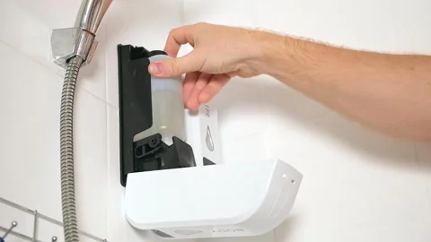 Man opens Chamber dispenser of soap Duo Shower Gel Shampoo and take out reusable Stock Footage 244789713