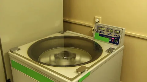 A man opens cover and withdraws contents from centrifuge Stock Footage 58401193