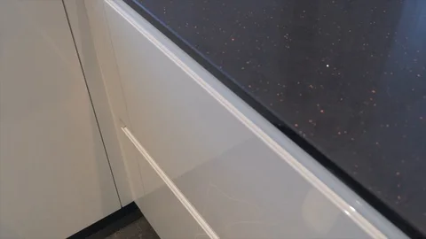 A man opens a cupboard in the kitchen Stock Footage 87645699