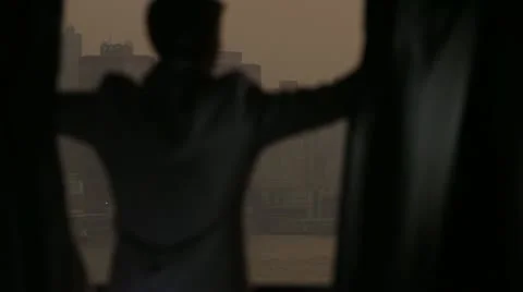 Man opens curtains on the view Hong Kong Stock-Footage 20488799