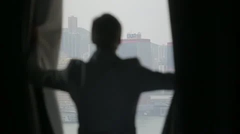 Man opens curtains on the view Hong Kong 2 Stock-Footage 20488914