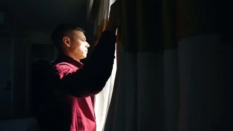 Man opens curtains on the view New York Stock Footage 76058216