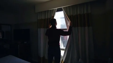 Man opens curtains on the view New York Stock Footage 76058220