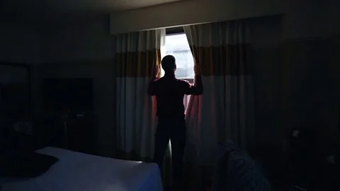 Man opens curtains on the view New York Stock Footage 76058266