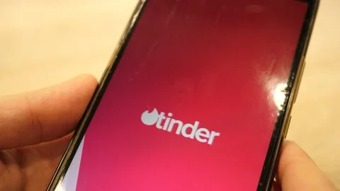 A Man opens Dating app Tinder on Mobile Smart Phone Stock-Footage 169653179