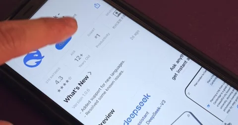 Man opens DeepSeek app on an iPhone Stock Footage 300406616