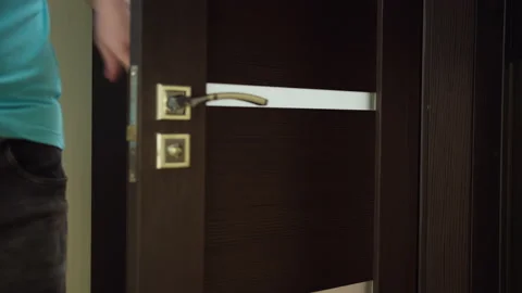 Man opens the door and exits the bathroom, tracking camera Stock Footage 145254364