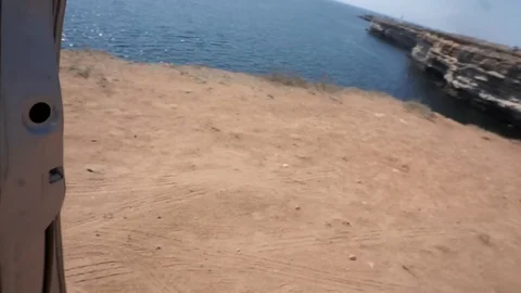 Man opens the door and gets out of a car on a mountain above the sea Stock Footage 103076788