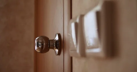 Man opens the door to the bathroom and enters Stock Footage 115986581