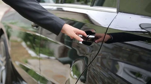 Man opens the door of the car in close-up, sets in the car and closes the door Stock Footage 80025714
