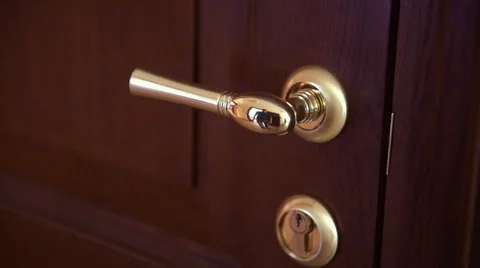 A man opens the door with the gilded handle Stock-Footage 64263391