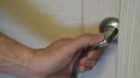 The man opens the door to the room. Stock Footage 96885432